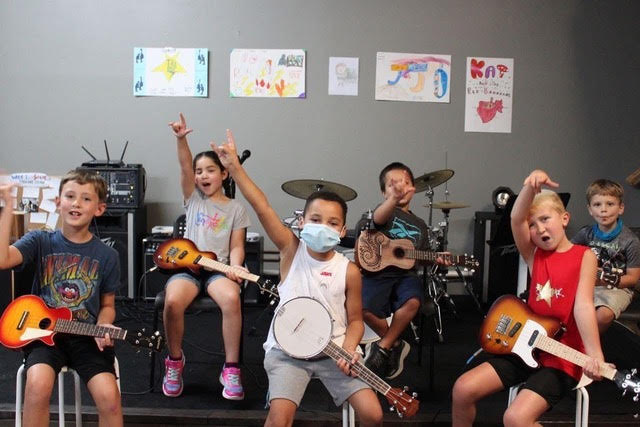 Stickandstrum Academy Summer Camps Kids rocking out at Stickandstrum Academy's Rockband Camp